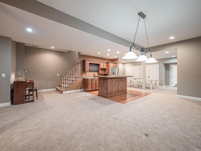 kitchen with recessed lighting, light colored carpet, a kitchen island, and stainless steel refrigerator with ice dispenser