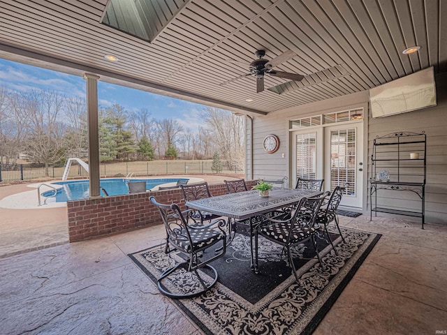 view of patio / terrace featuring ceiling fan, outdoor dining space, a fenced backyard, and a fenced in pool