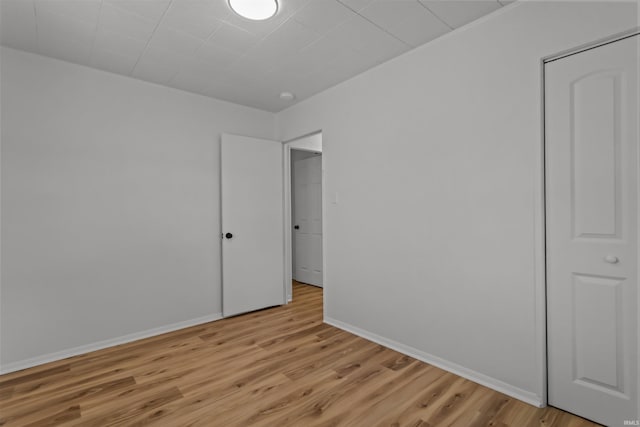 unfurnished bedroom with light wood finished floors and baseboards