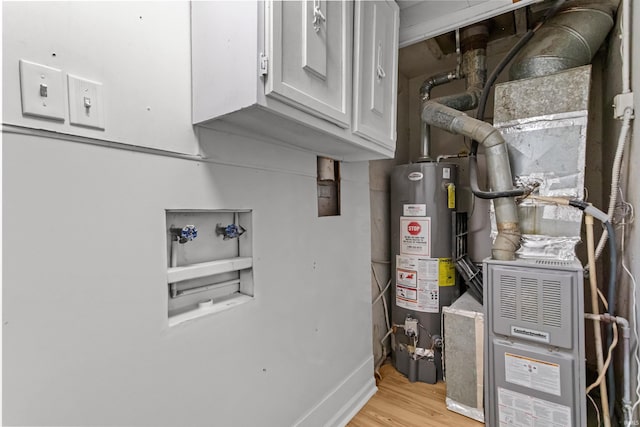 utility room featuring water heater