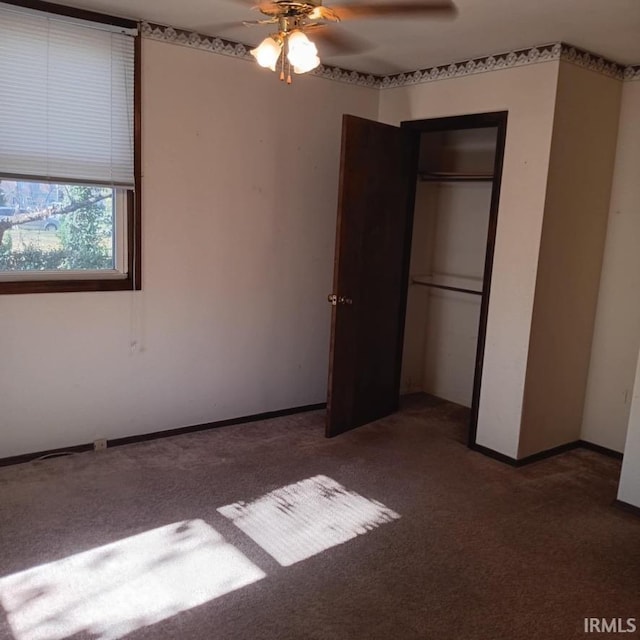 unfurnished bedroom featuring a ceiling fan, carpet, a closet, and baseboards