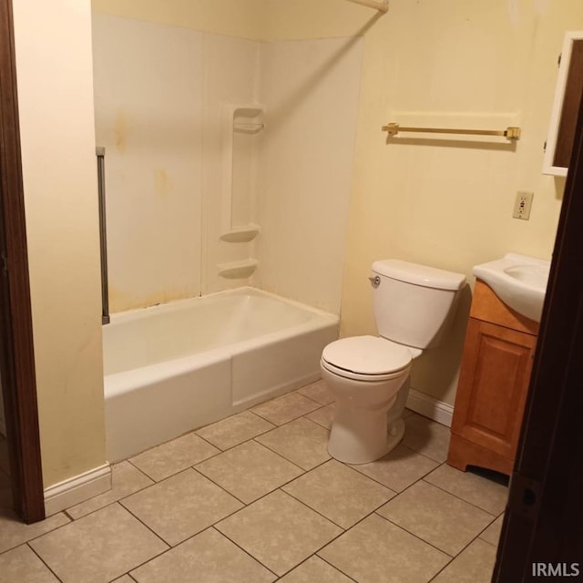 full bathroom featuring baseboards, toilet, tile patterned flooring, vanity, and shower / washtub combination