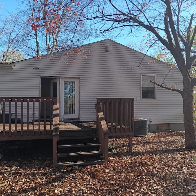 back of property with a deck and cooling unit