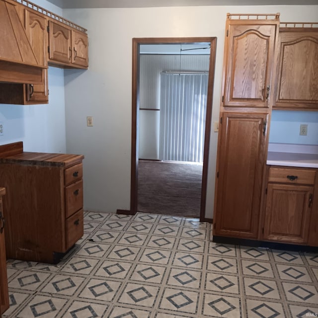 kitchen featuring brown cabinets, light floors, and light countertops