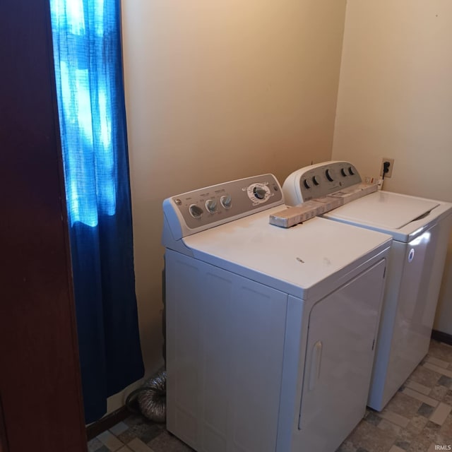 washroom featuring laundry area and washing machine and clothes dryer