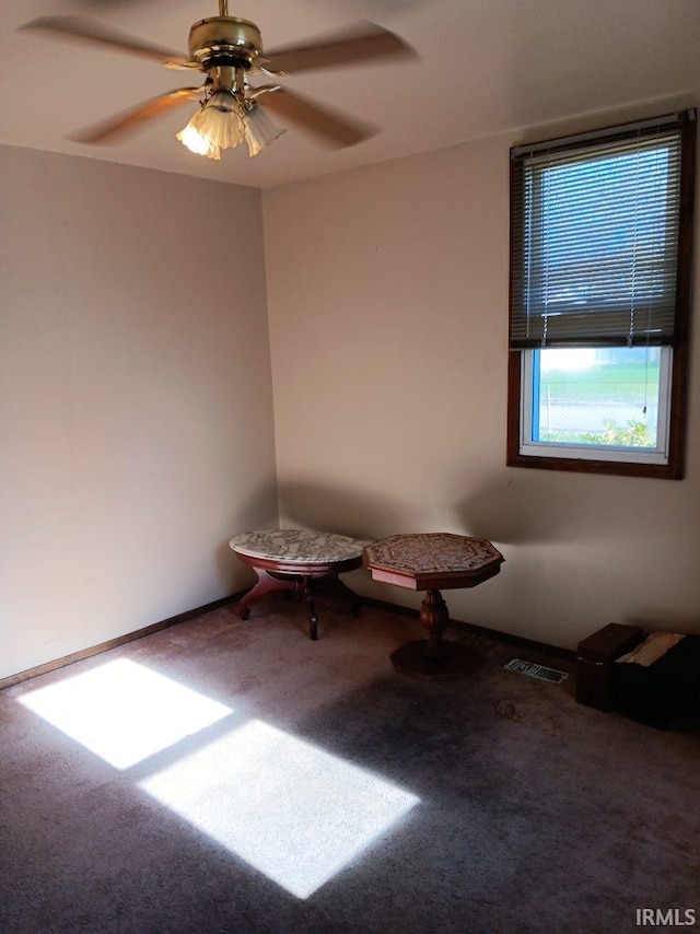 spare room with ceiling fan, carpet floors, and visible vents