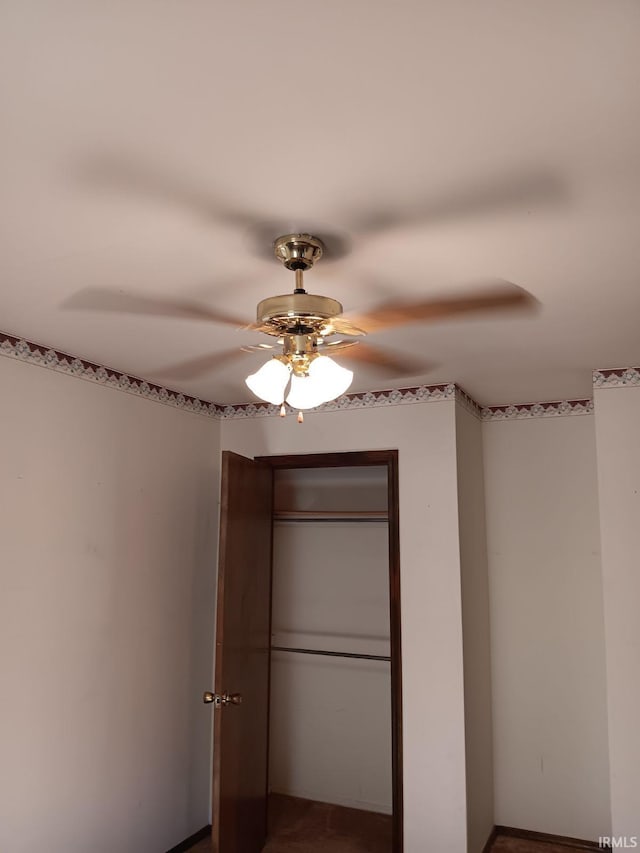 unfurnished bedroom with a closet and ceiling fan