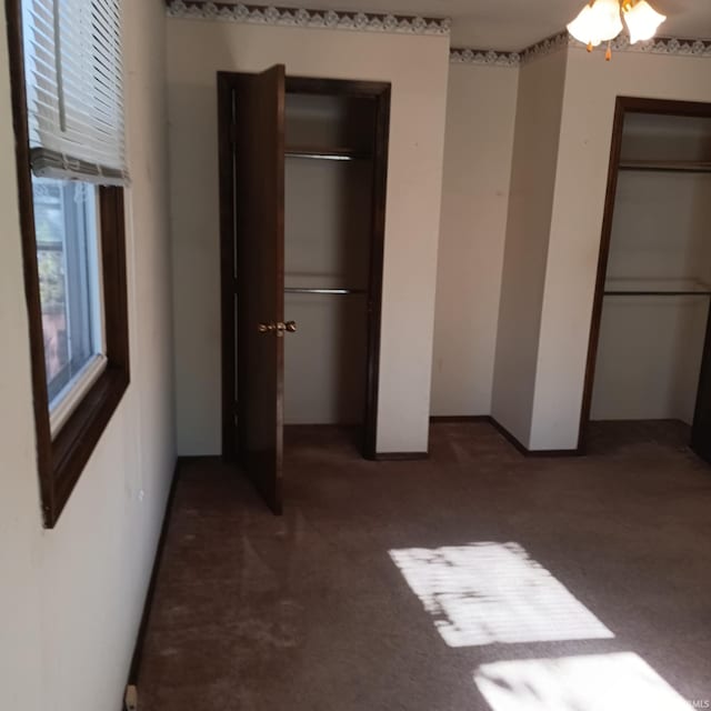 unfurnished bedroom with carpet floors, a closet, and baseboards