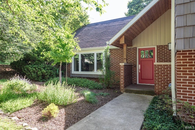 doorway to property with brick siding