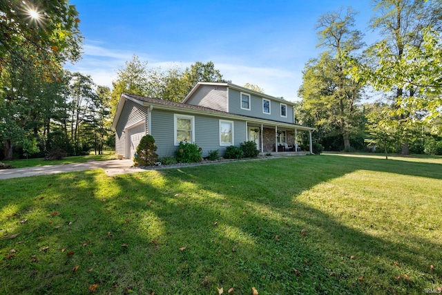 traditional-style home with a garage, driveway, covered porch, and a front yard