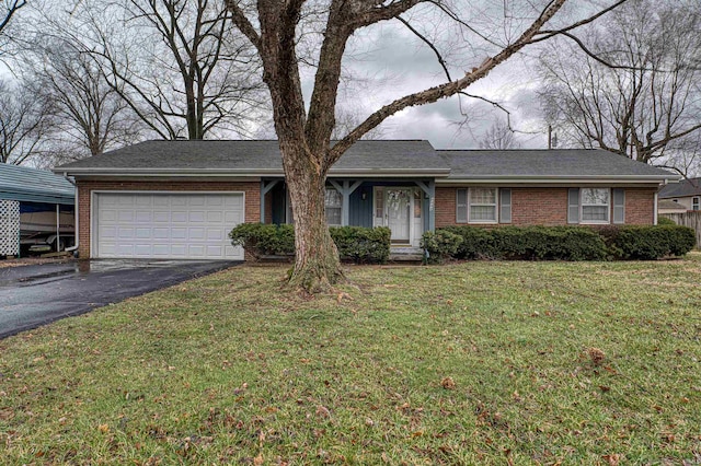 ranch-style house featuring an attached garage, a front lawn, aphalt driveway, and brick siding