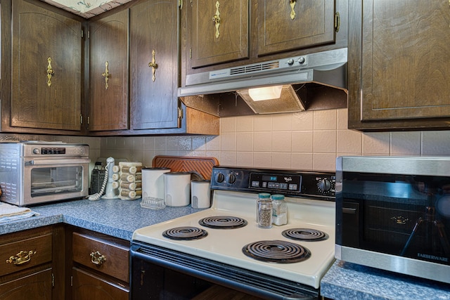 kitchen featuring dark brown cabinetry, under cabinet range hood, electric range, and decorative backsplash