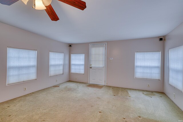 empty room with carpet floors and ceiling fan