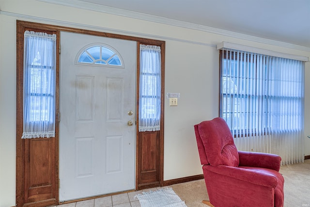 foyer entrance with plenty of natural light, ornamental molding, and baseboards