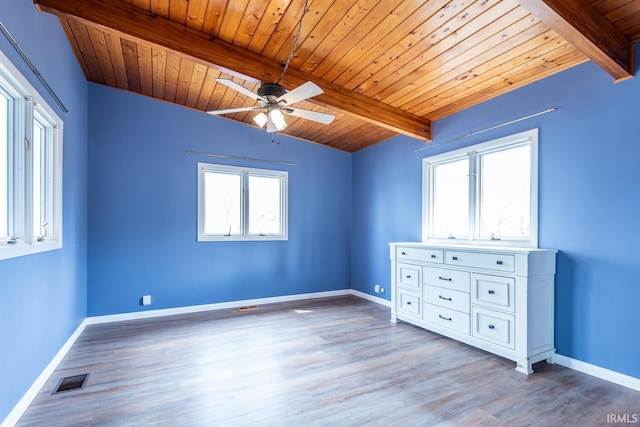 unfurnished bedroom featuring beamed ceiling and baseboards