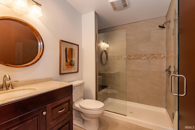 bathroom featuring toilet, a stall shower, visible vents, and vanity