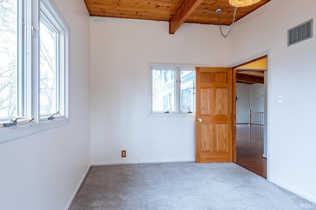 unfurnished bedroom with carpet floors, wood ceiling, visible vents, and beamed ceiling