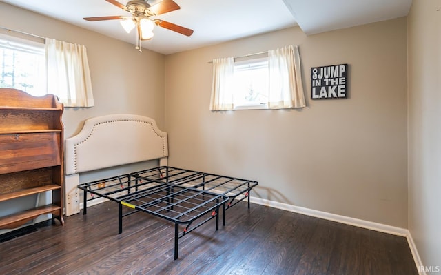 recreation room with baseboards, wood finished floors, and a healthy amount of sunlight