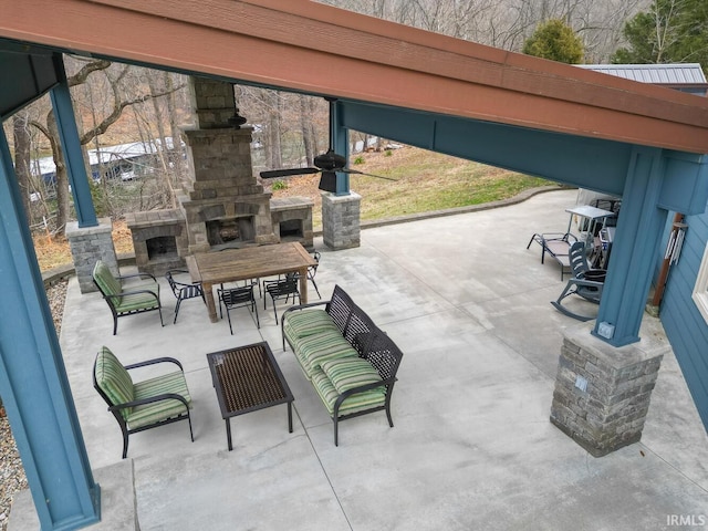 view of patio / terrace with an outdoor stone fireplace