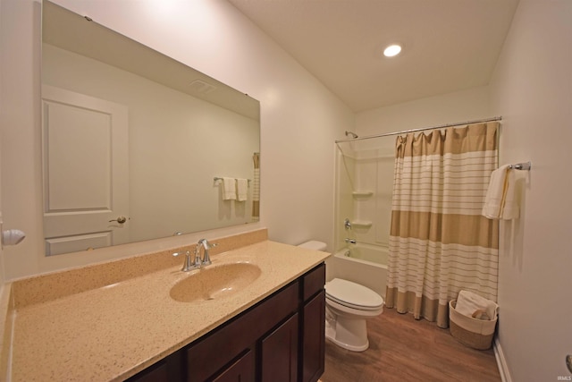 bathroom featuring shower / bath combination with curtain, vanity, toilet, and wood finished floors