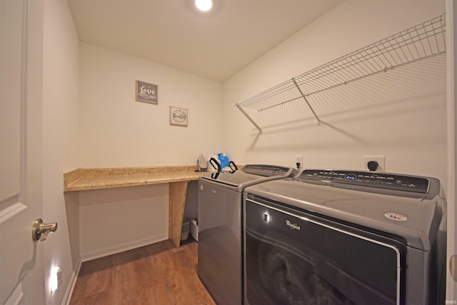 washroom featuring dark wood-style floors, laundry area, baseboards, and separate washer and dryer