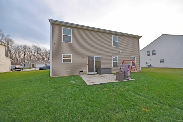 back of house with central air condition unit, a lawn, and a patio