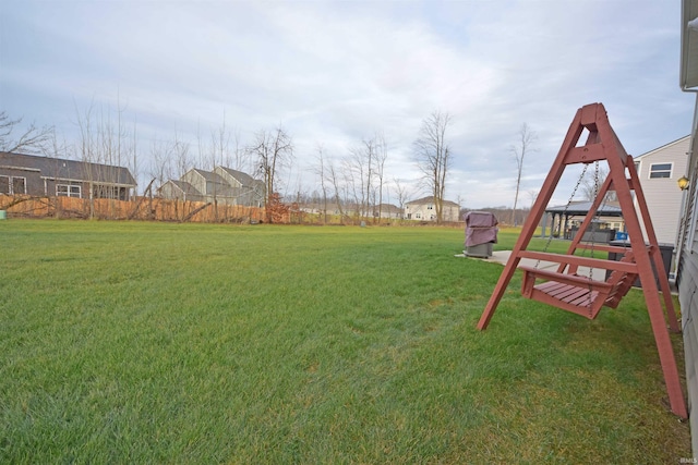 view of yard featuring fence and a playground