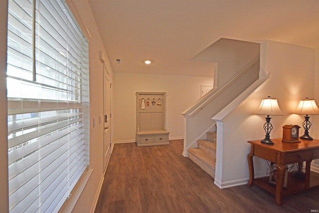 corridor featuring baseboards, stairway, wood finished floors, and recessed lighting