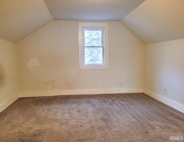 bonus room with vaulted ceiling, carpet, and baseboards