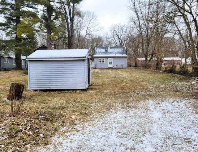 view of yard with a storage unit and an outbuilding