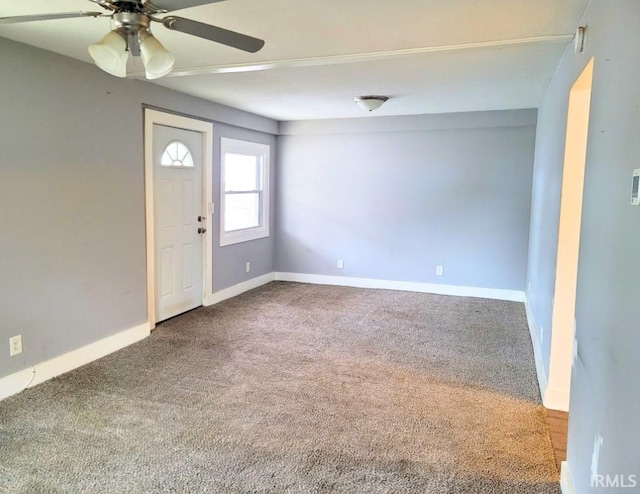 entrance foyer with carpet floors, a ceiling fan, and baseboards