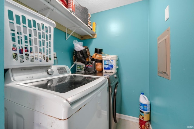 laundry room featuring washer and dryer, laundry area, and baseboards