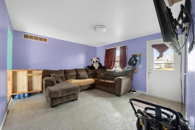 living area featuring carpet floors and visible vents