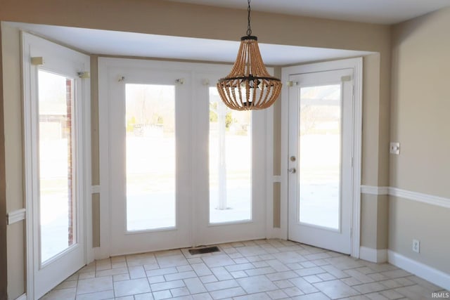 doorway with visible vents, a wealth of natural light, and french doors