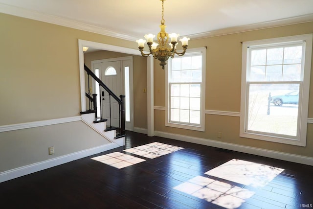 foyer with ornamental molding, dark wood-type flooring, and baseboards