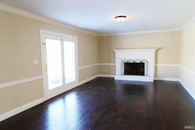 unfurnished living room with a fireplace with raised hearth, visible vents, baseboards, and wood finished floors