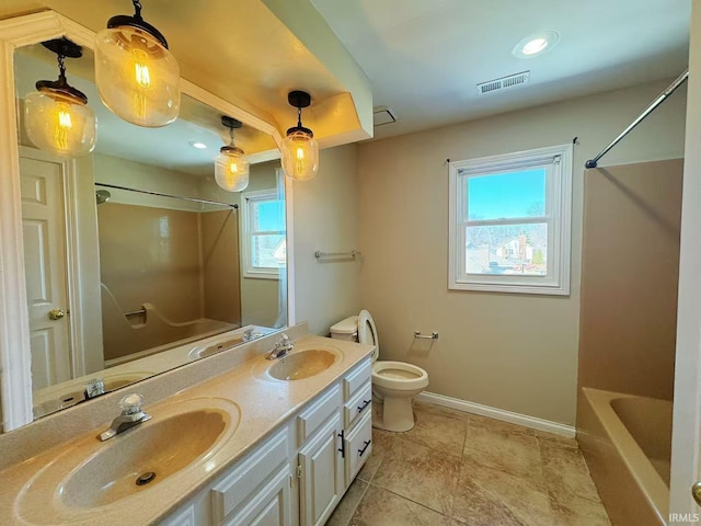 bathroom featuring toilet, visible vents, baseboards, and a sink