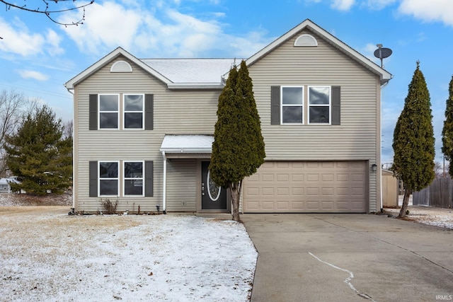 traditional-style home with concrete driveway, an attached garage, and fence