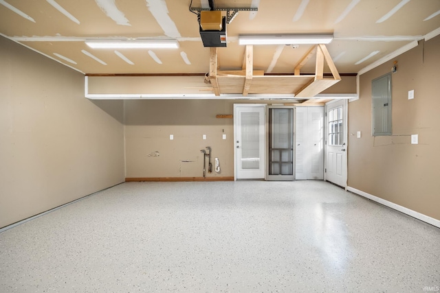 garage with a garage door opener, electric panel, and baseboards