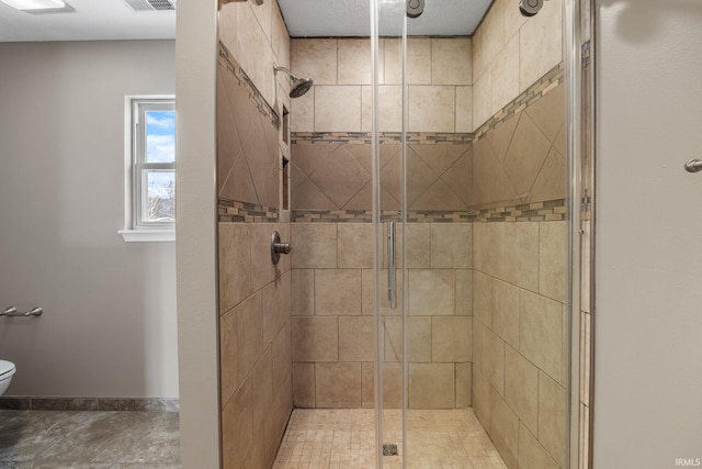 full bathroom featuring toilet, a shower stall, visible vents, and baseboards