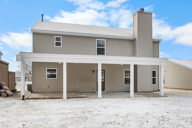 rear view of property featuring a chimney