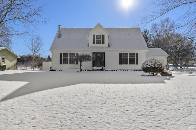 snow covered back of property with entry steps and fence