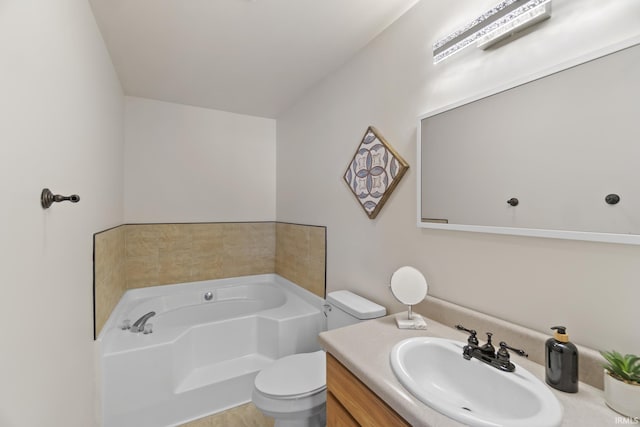 bathroom featuring vanity, a garden tub, and toilet