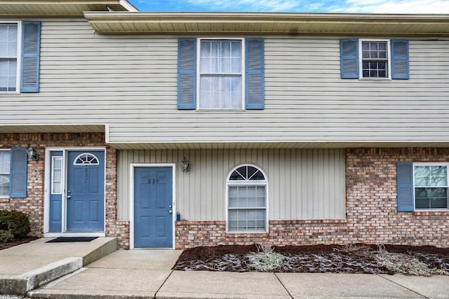 townhome / multi-family property featuring brick siding