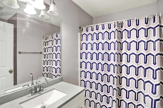 bathroom with curtained shower, visible vents, and vanity