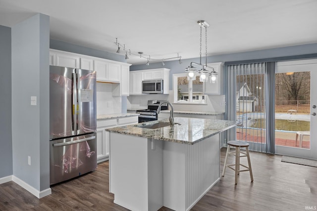 kitchen featuring stainless steel appliances, white cabinets, dark wood-type flooring, and a sink