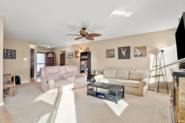 living room featuring carpet flooring, a ceiling fan, and baseboards