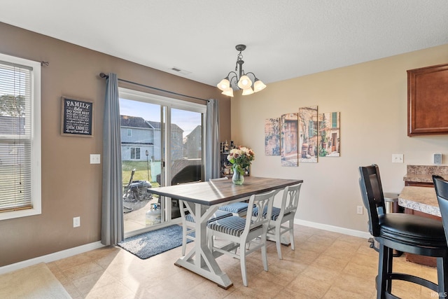 dining room with an inviting chandelier, visible vents, and baseboards