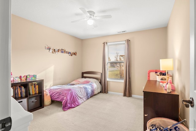 bedroom with a ceiling fan, visible vents, light carpet, and baseboards