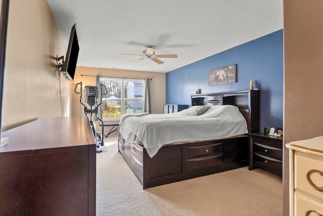 carpeted bedroom with a textured ceiling and ceiling fan